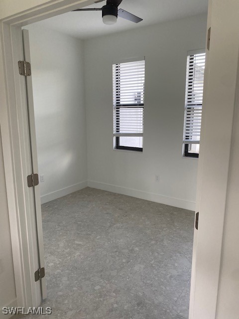 spare room featuring a wealth of natural light and ceiling fan