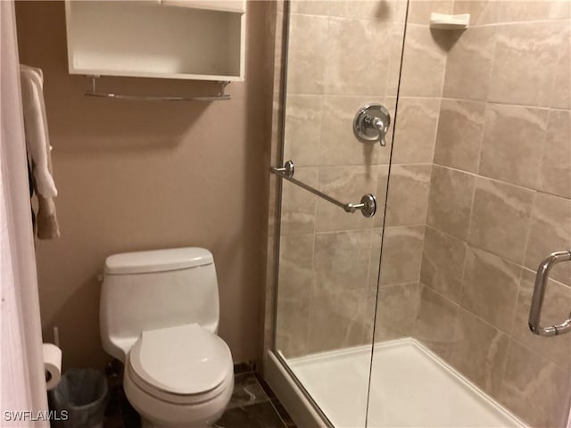 bathroom featuring toilet and walk in shower