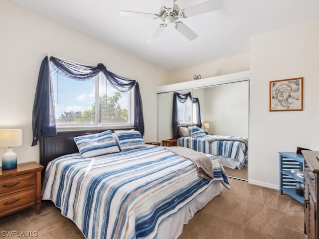 bedroom with carpet floors, ceiling fan, and a closet