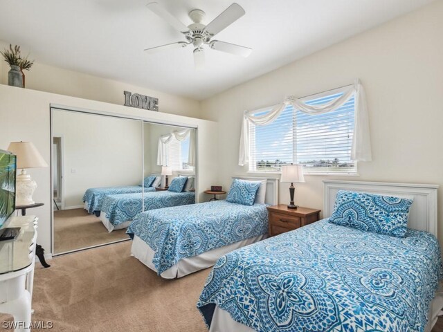 bedroom with carpet, ceiling fan, and a closet