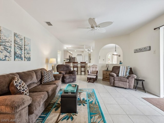 tiled living room with ceiling fan