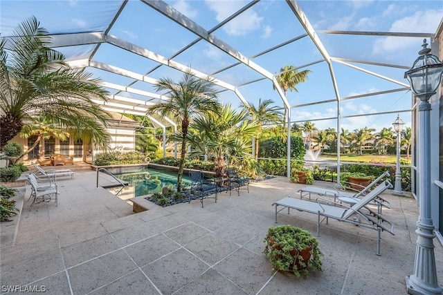 view of swimming pool with a patio area and glass enclosure