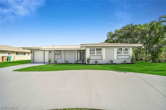 ranch-style home featuring a front lawn and a garage