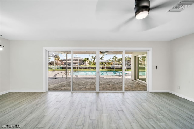 unfurnished room with ceiling fan and light hardwood / wood-style flooring