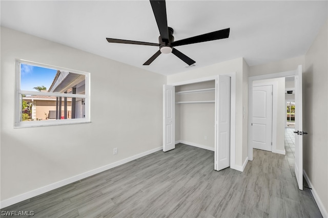 unfurnished bedroom with a closet, ceiling fan, and light hardwood / wood-style flooring