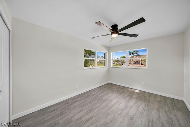 empty room with ceiling fan and light wood-type flooring