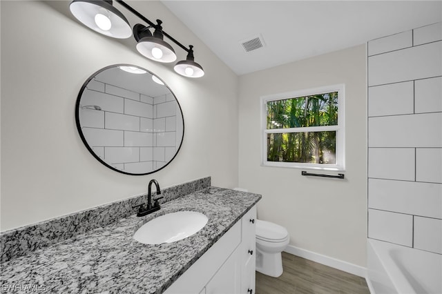 full bathroom featuring toilet, vanity, shower / bath combination, and hardwood / wood-style flooring