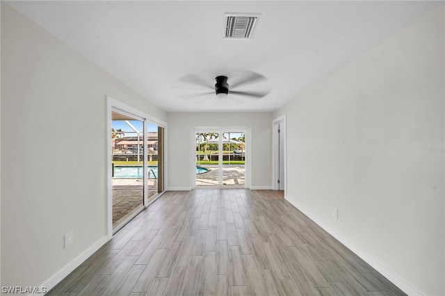 spare room with light hardwood / wood-style floors and ceiling fan