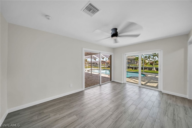 spare room with hardwood / wood-style floors and ceiling fan