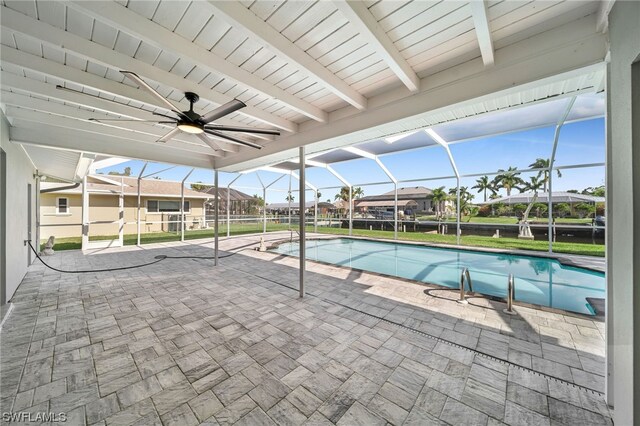 view of swimming pool featuring glass enclosure, ceiling fan, and a patio