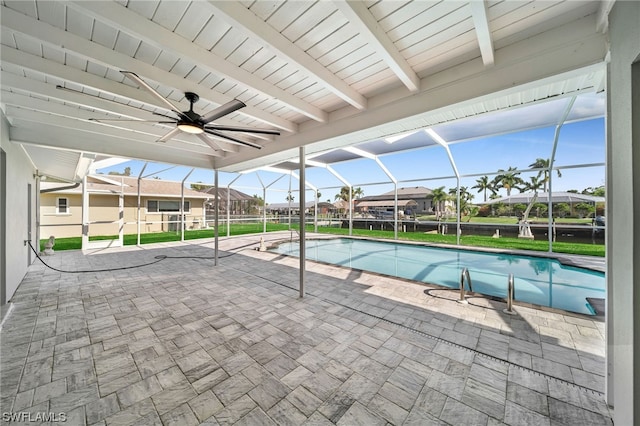 view of pool featuring a patio area, ceiling fan, and glass enclosure