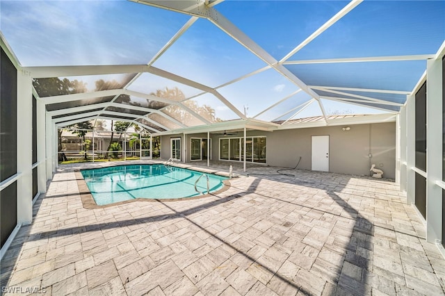 view of swimming pool featuring a patio and a lanai