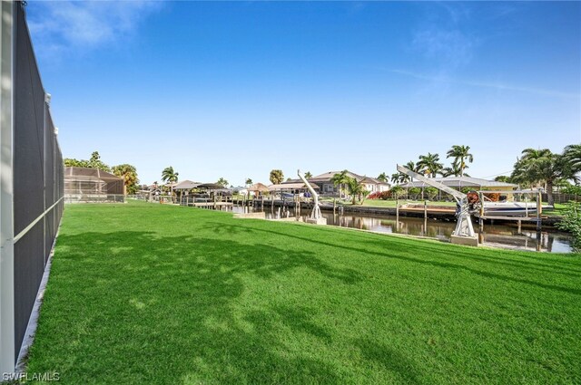 view of yard with a dock and a water view