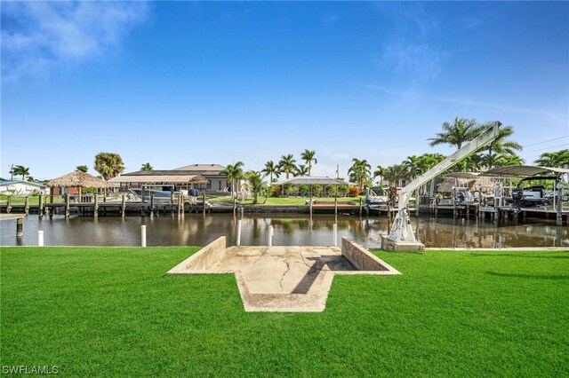 view of dock featuring a water view and a yard