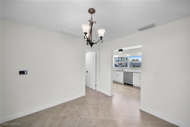 tiled empty room featuring sink and a chandelier