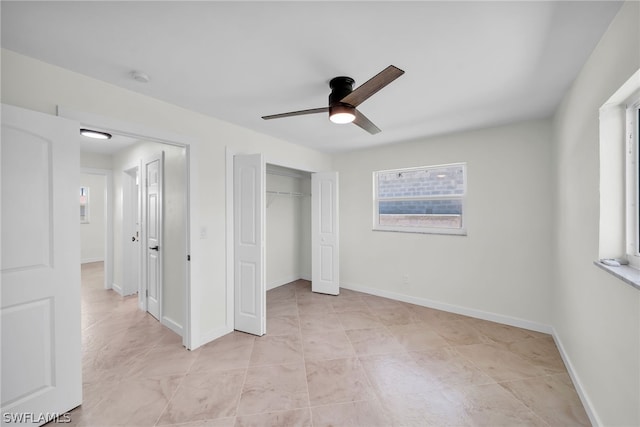 unfurnished bedroom with a closet, ceiling fan, light tile floors, and multiple windows