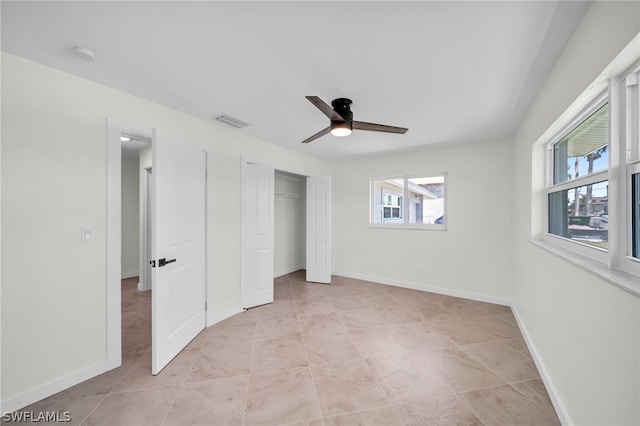 unfurnished bedroom with ceiling fan and light tile floors