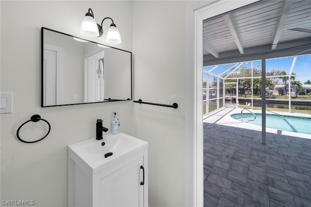 bathroom with oversized vanity and beam ceiling