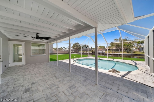 view of swimming pool featuring a lanai, a yard, ceiling fan, and a patio area