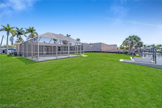 view of yard featuring a water view and glass enclosure