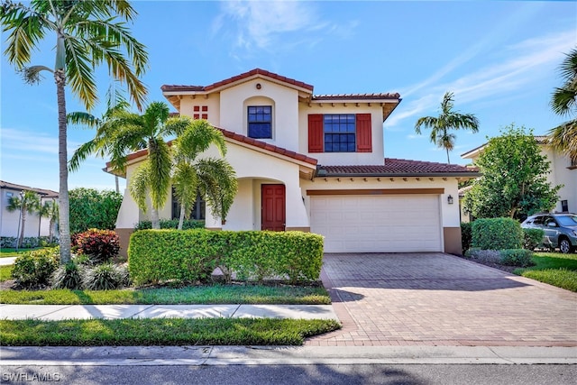 mediterranean / spanish house with a garage