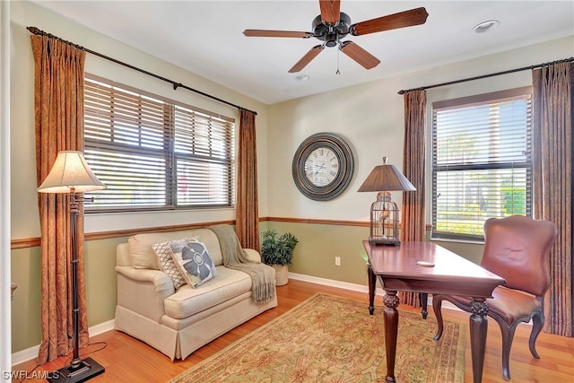 living area featuring ceiling fan and light hardwood / wood-style flooring