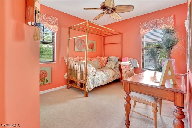 bedroom featuring multiple windows, ceiling fan, and carpet floors