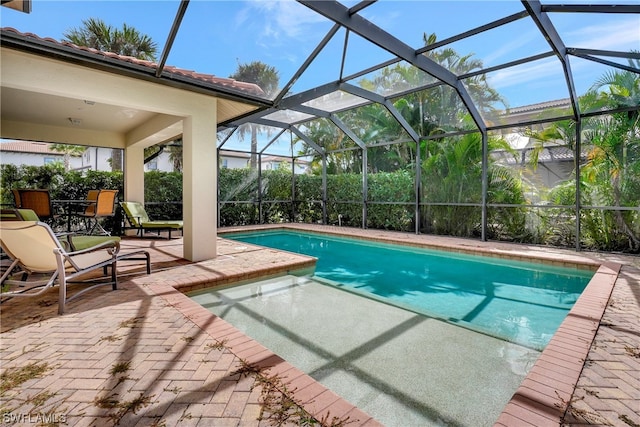 view of pool with a lanai and a patio