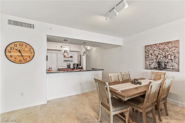 dining space featuring track lighting