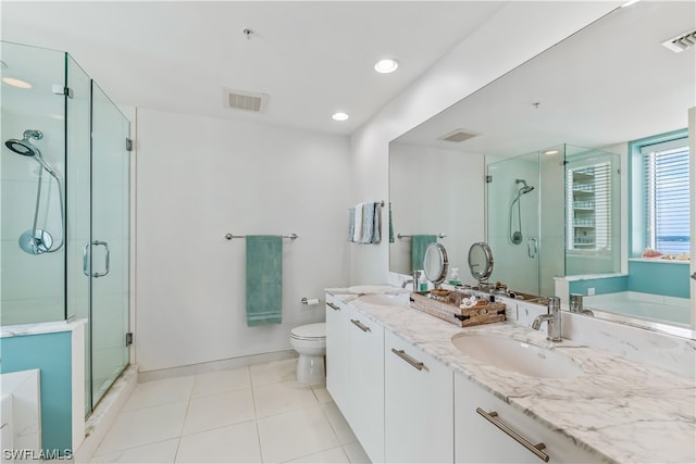 full bathroom featuring tile patterned flooring, vanity, separate shower and tub, and toilet