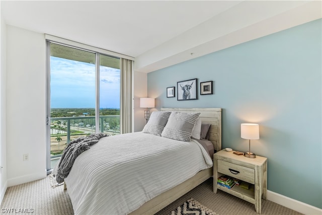 carpeted bedroom with floor to ceiling windows and access to exterior