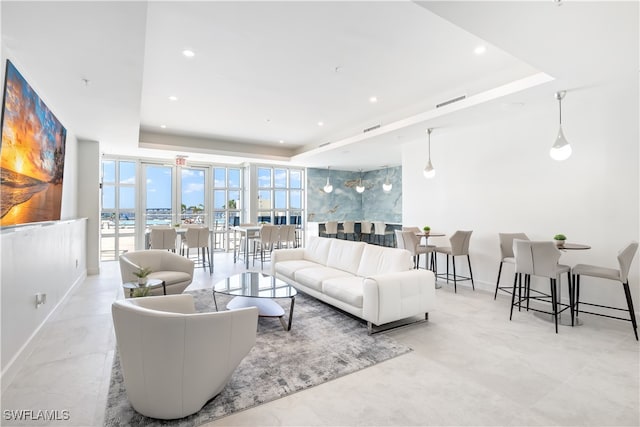 living room featuring a tray ceiling