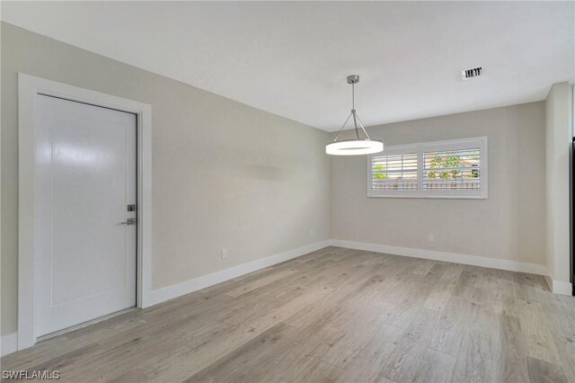 unfurnished room featuring light wood-type flooring