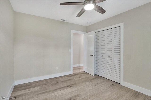 unfurnished bedroom featuring a closet, ceiling fan, and light wood-type flooring