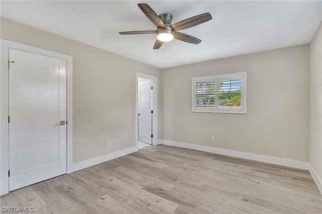 unfurnished bedroom with light hardwood / wood-style flooring, a closet, and ceiling fan