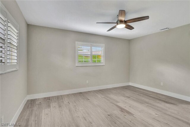 unfurnished room with light wood-type flooring and ceiling fan