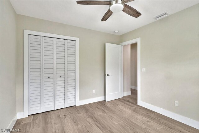 unfurnished bedroom with a closet, ceiling fan, and light wood-type flooring