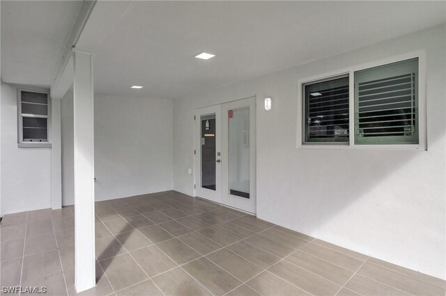 property entrance featuring a patio and french doors