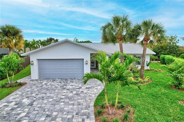 view of front of house with a garage and a front yard