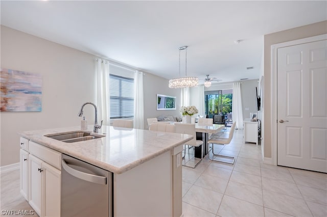 kitchen with light tile patterned flooring, sink, a kitchen island with sink, and stainless steel dishwasher