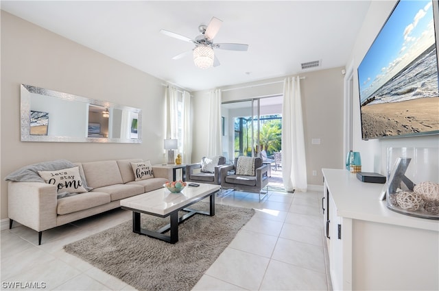 tiled living room featuring ceiling fan