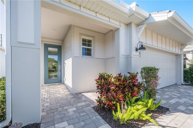 doorway to property with a garage