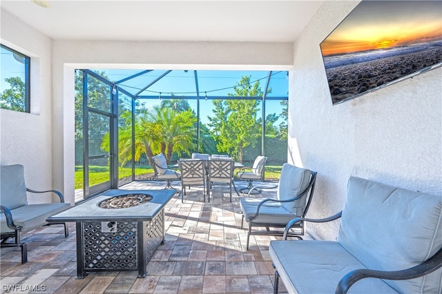 view of patio / terrace with a lanai and an outdoor fire pit