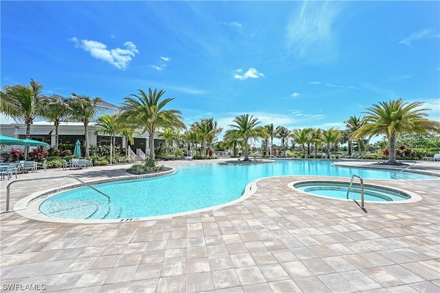 view of pool featuring a community hot tub and a patio area