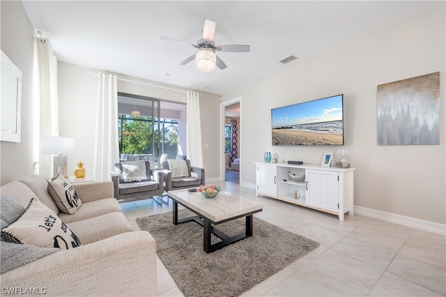 tiled living room with ceiling fan