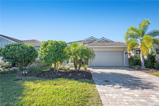 view of front of home with a garage and a front lawn