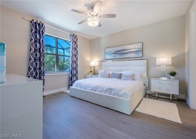 bedroom with ceiling fan and light hardwood / wood-style flooring