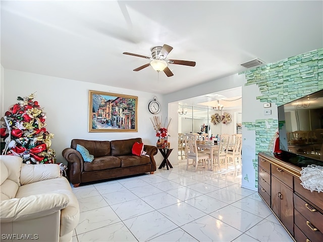 living room with ceiling fan with notable chandelier