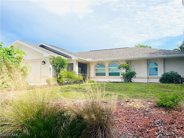 ranch-style house with a garage and a front yard