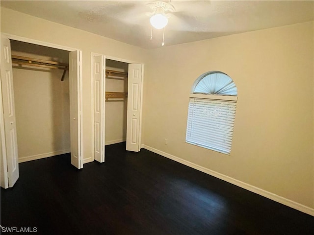 unfurnished bedroom featuring dark hardwood / wood-style flooring and ceiling fan